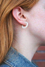 Load image into Gallery viewer, Close-up of a person wearing a white U-shaped earring.
