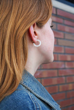 Load image into Gallery viewer, Person wearing a hoop earring with a brick wall background
